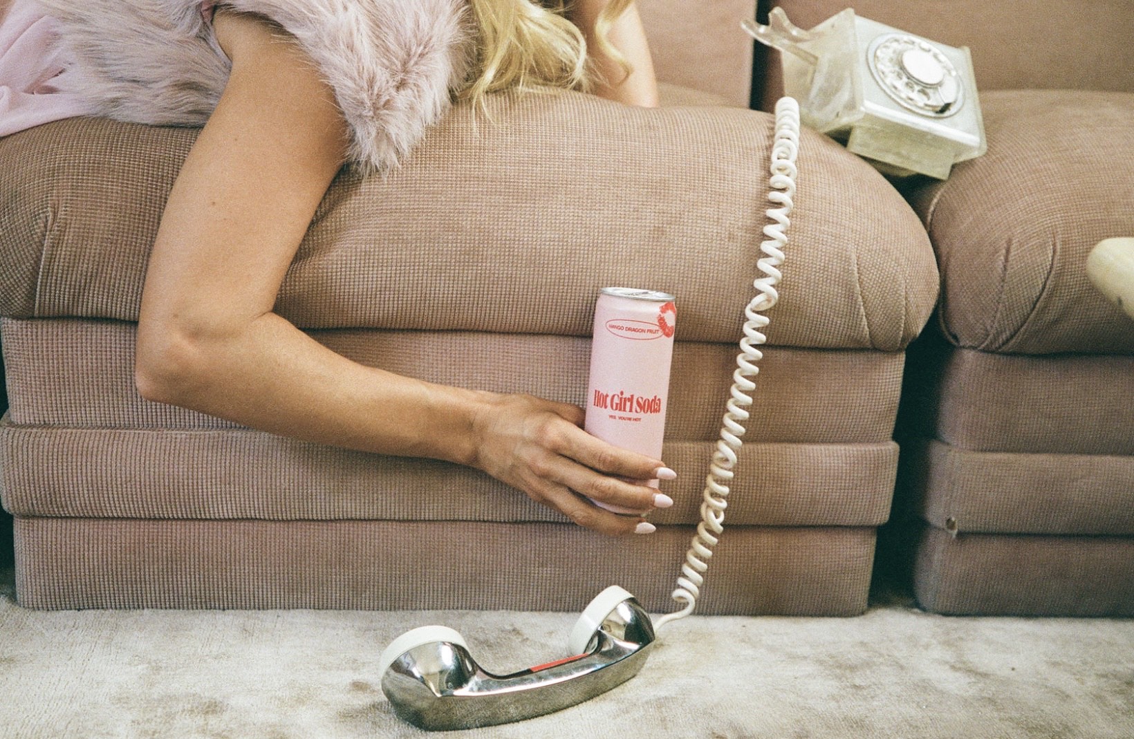 A can of Mango Dragon Fruit Hot Girl Soda beside a vintage telephone